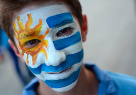 An Uruguayan boy painted with colours of his national flag waits for a FIFA World Cup soccer match between Uruguay and Costa Rica at Arena Castelao in Fortaleza, Brazil, Saturday, June 14, 2014.